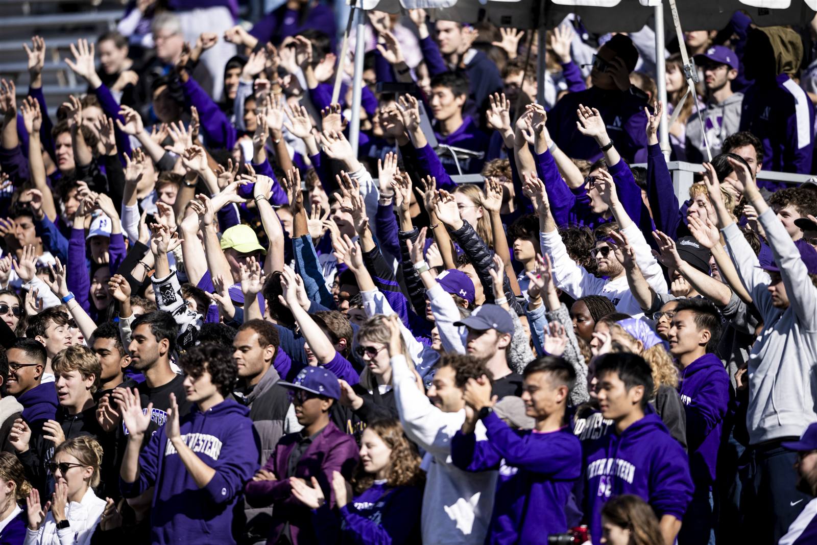 Students in purple cheering in the stands