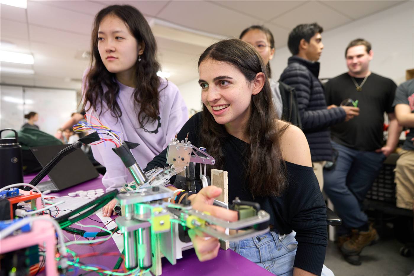 Students building a robot in a class